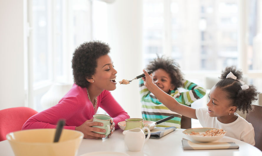 Kids feeding mom breakfast