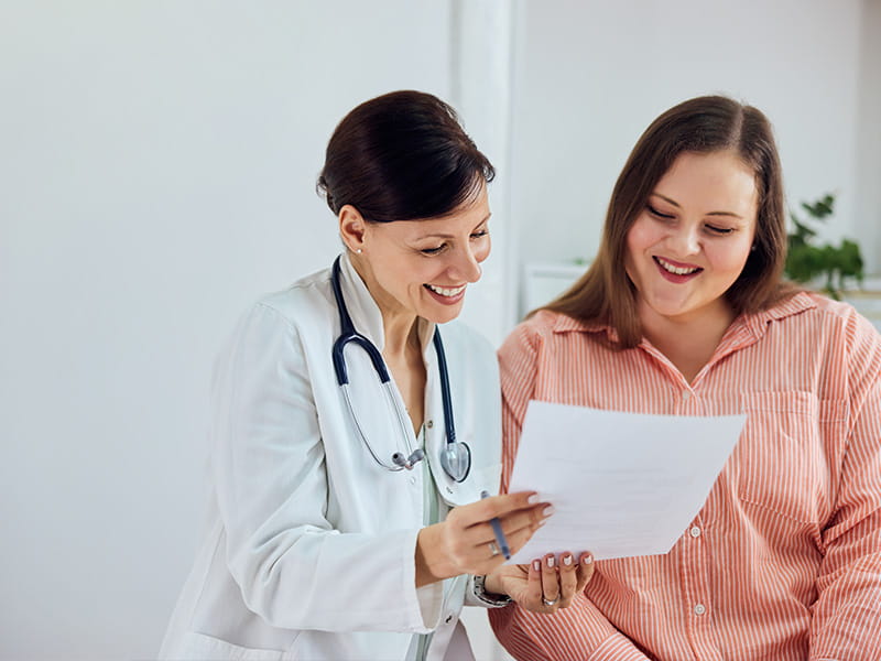Clinician showing a document to a patient
